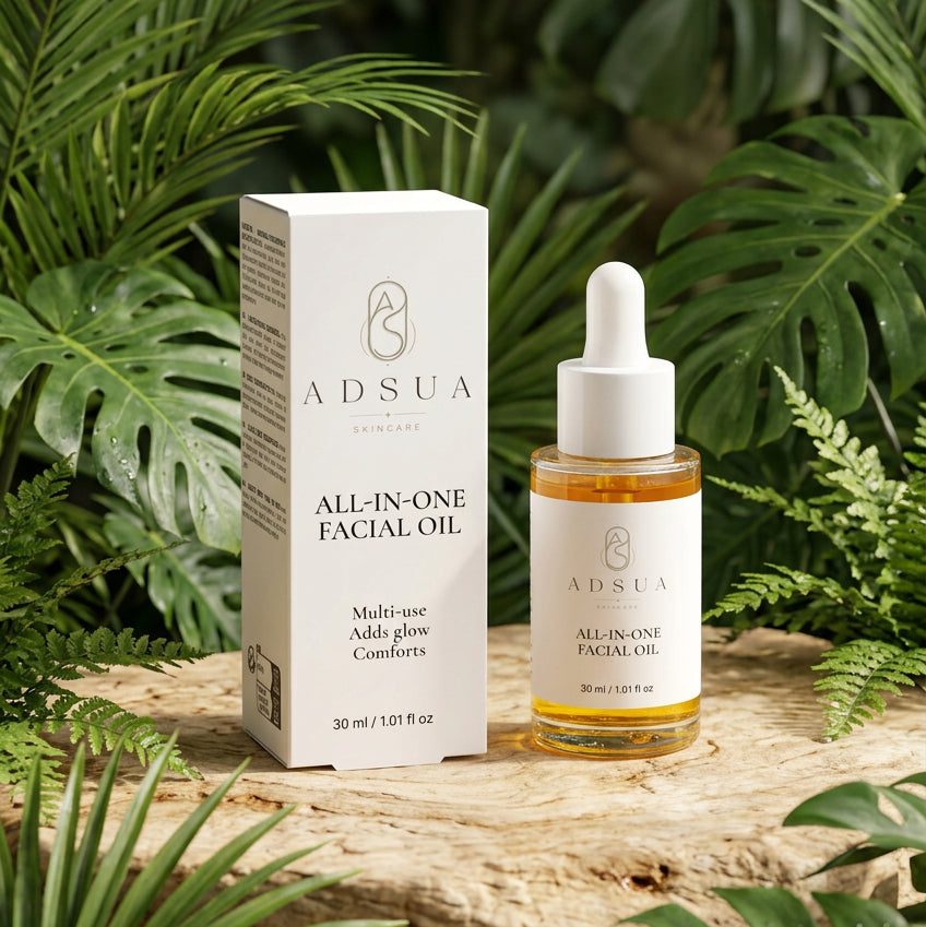 Adsua All-In-One Facial Oil van 30 ml naast het doosje, amberkleurige olie in een glazen pipetflesje